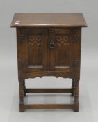 A carved oak pot cupboard. 51 cm wide x 68 cm high.