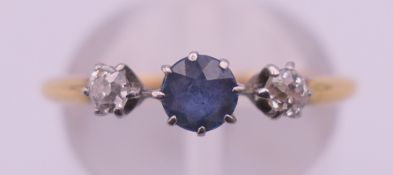 An 18 ct gold diamond and blue stone ring. Ring size M/N. 2.3 grammes total weight.