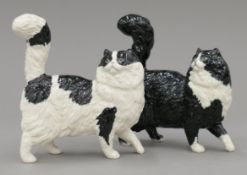 Two Royal Doulton porcelain cats. 13.5 cm high.