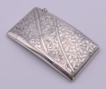 An Edwardian silver card case with concealed stamp section. 8 x 4.5 cm.