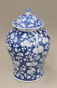 A 19th century Chinese prunus blossom porcelain lidded vase. 41 cm high.