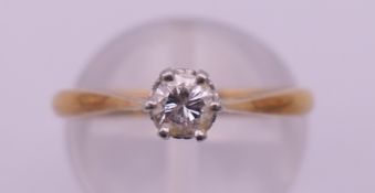 An 18 ct gold diamond solitaire ring. Ring size M/N. 2.8 grammes total weight.