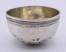 An early silver tumbler, the bowl inset with a coin. 5.8 cm diameter.