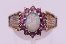 A 9 ct gold opal and pink spinel ring. Ring size 4.5 grammes total weight.