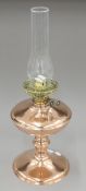 A copper and brass oil lamp. 54 cm high overall.