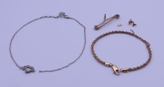 An 18 ct gold bracelet, a Thomas Sabo heart necklace, a metal brooch and a single dolphin earring.