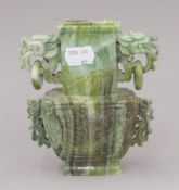 A Chinese carved green stone vase. 14 cm high.