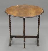 An early 20th century bobbin twist folding side table. 73 cm diameter.