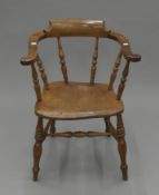 A Victorian cherry wood and elm smoker's bow armchair. 62 cm wide.