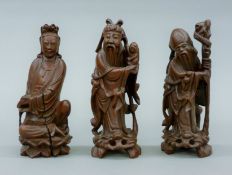 Three antique Chinese carved wooden figures. The largest 20.5 cm high.
