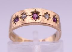 A 15 ct gold five-stone ruby and diamond ring. Ring size L. 2.4 grammes total weight.
