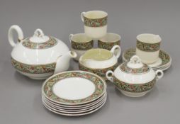 A Belleek porcelain tea set. The teapot 25 cm long.