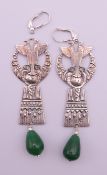 A pair of silver Art Deco Egyptian Revival earrings. 8.5 cm high including suspension hook.