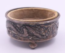 A Chinese silver salt with dragon design and later insert. 6.5 cm diameter. 46.6 grammes.