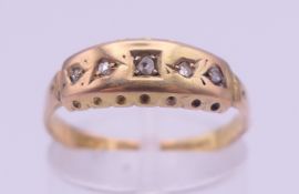 A 15 ct gold five-stone ring. Ring size O. 2 grammes total weight.