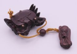 A hardwood inro formed as a crab, the netsuke formed as an octopus. Inro 8 x 6 cm.