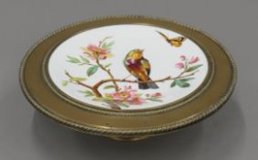 A Victorian bronze and porcelain comport. 32 cm diameter.