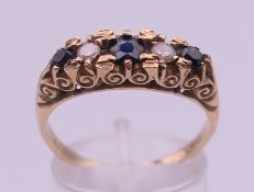 A 9 ct gold five-stone sapphire and diamond ring. Ring size S/T. 4 grammes total weight.