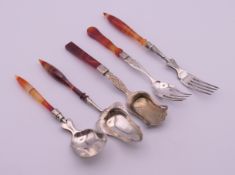 Three continental silver and agate caddy spoons and two silver and agate forks.
