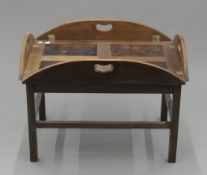 A mahogany butler's tray on stand. 79 cm long.