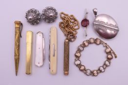 Two propelling pencils, two white metal buttons, a cameo bracelet, a white metal locket,