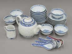 A quantity of Chinese 'rice grain' tea and soup service. The teapot 23 cm long.