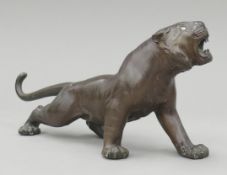 A Japanese Meiji period patinated bronze model of a tiger. 30 cm long.