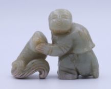 A jade carving of a man and a fish. 5 cm high.