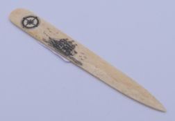 A bone scrimshaw page turner. 16.5 cm long.