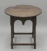 A Victorian carved oak side table. 68.5 cm wide.