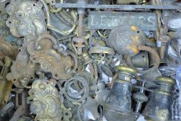 A quantity of brass door and furniture fittings, a stirrup pump etc. The pump 75 cm high.