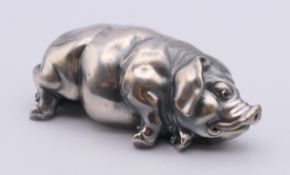 A silver model of a pig with red inset eyes bearing Russian marks. 7 cm long.