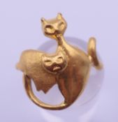 A 24 ct gold handmade cat design ring formed as two cats, one polished and one matt. Ring size N. 6.