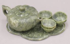 A Chinese spinach jade tea set. The teapot 16 cm long.