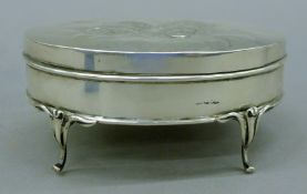 An Edwardian silver jewellery box embossed with cherubs. 14 cm wide. 242.3 grammes total weight.