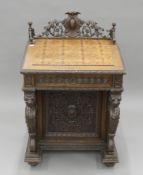 A Victorian carved oak pop-up top Davenport. 64.5 cm wide.