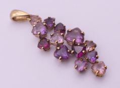 A 9 ct gold amethyst pendant. 4 cm high including suspension loop. 2.7 grammes total weight.