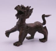 A bronze model of a dog-of-fo. 7 cm high.