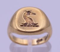 An 18 ct gold signet ring with engraved dog intaglio. Ring size J/K. 12.1 grammes.