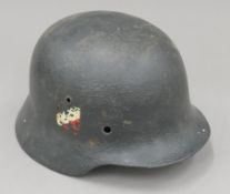 A German Luftwaffe-style tin helmet. 22.5 cm wide.