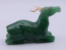 A silver gilt-mounted jade model of a deer. 8 cm long.