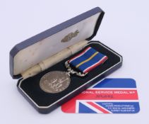 A boxed National Service 1939-1960 medal with identification card numbered 39492. Box 13 x 6 cm.