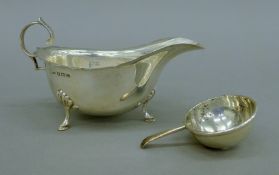 A silver sauce boat and a silver ladle. The former 16.5 cm long. 207.9 grammes.