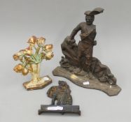 Three cast iron door stops. The largest 36 cm high.
