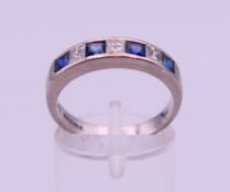 An 18 ct white gold, sapphire and diamond ring. Ring size O/P. 5.2 grammes total weight.
