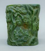 A Chinese carved green stone brush pot. 16 cm high.