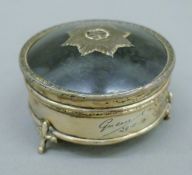A silver and tortoiseshell trinket box, the lid with Regimental crest. 7.5 cm diameter. 132.