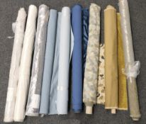 A quantity of bolts of various upholstery fabrics. The largest 166 cm wide.