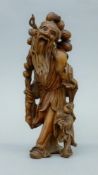 A Chinese hardwood carving of a man and boy. 25 cm high.