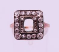 An unmarked 18 ct gold and diamond ring (centre stone lacking). Ring size O. 3.